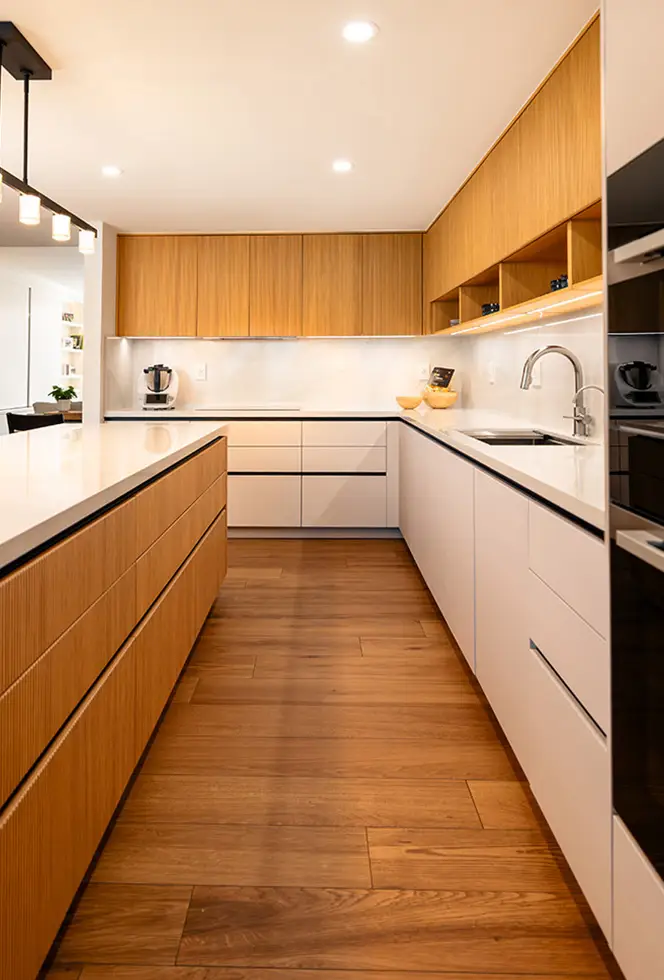 Modern kitchen with oak island cabinetry, handleless white uppers and an integrated sink run
