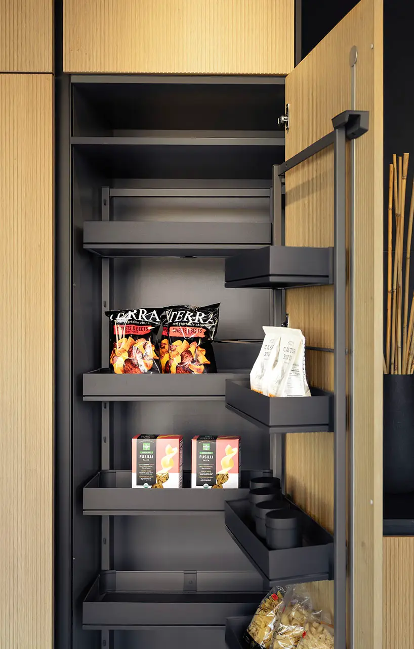 Tall pull-out larder with wire-framed shelves holding packaged food